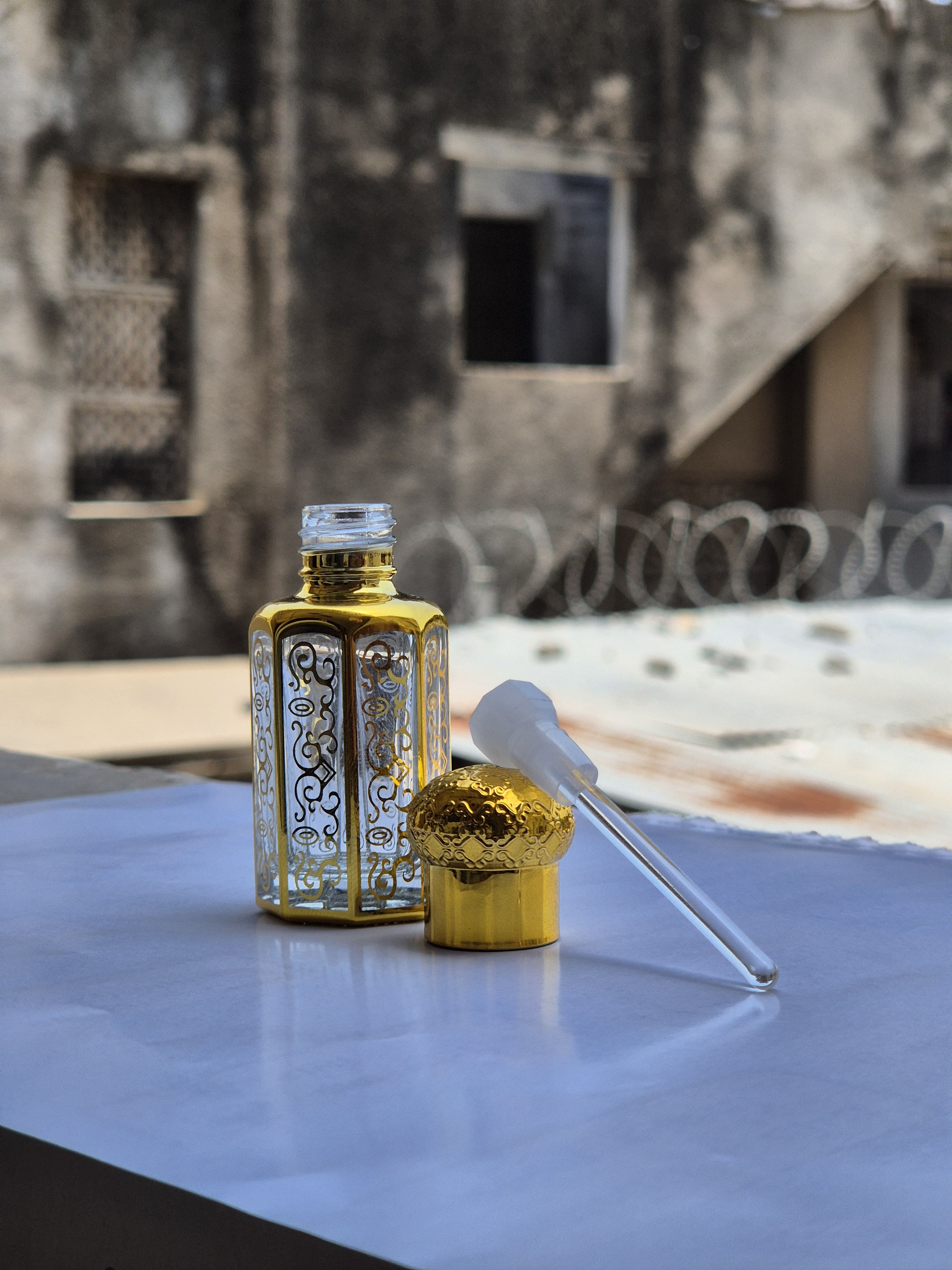 A traditional gold filigree attar dropper bottle, the ITRIKA way of making perfume in Surat